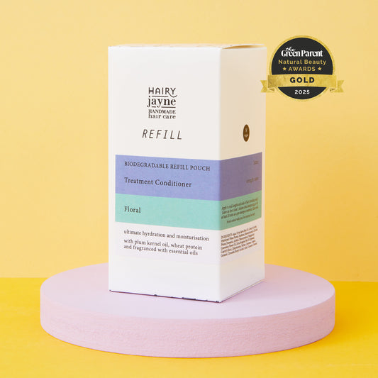 Hairy Jayne refill box for treatment conditioner on a pink platform with a yellow background with 2025 award logo