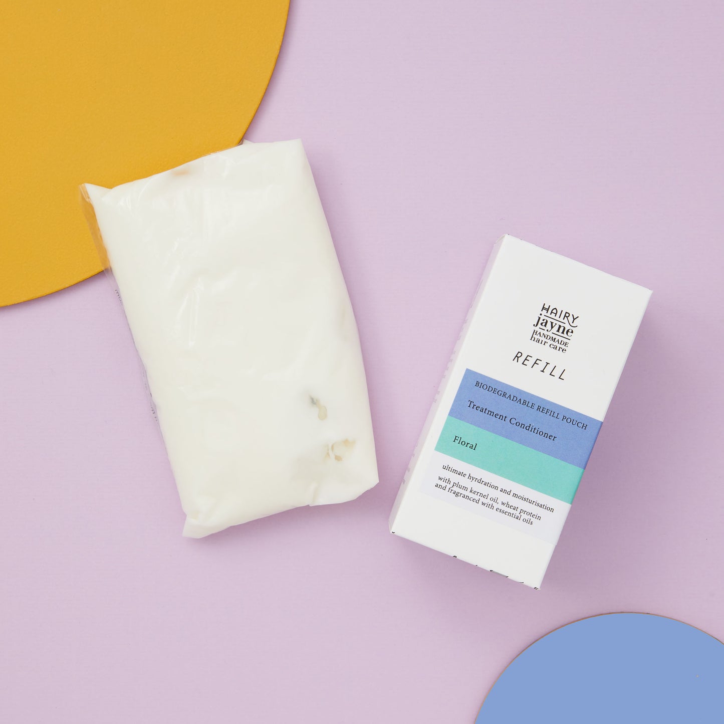 Treatment conditioner refill pouch and its packaging on a pastel background