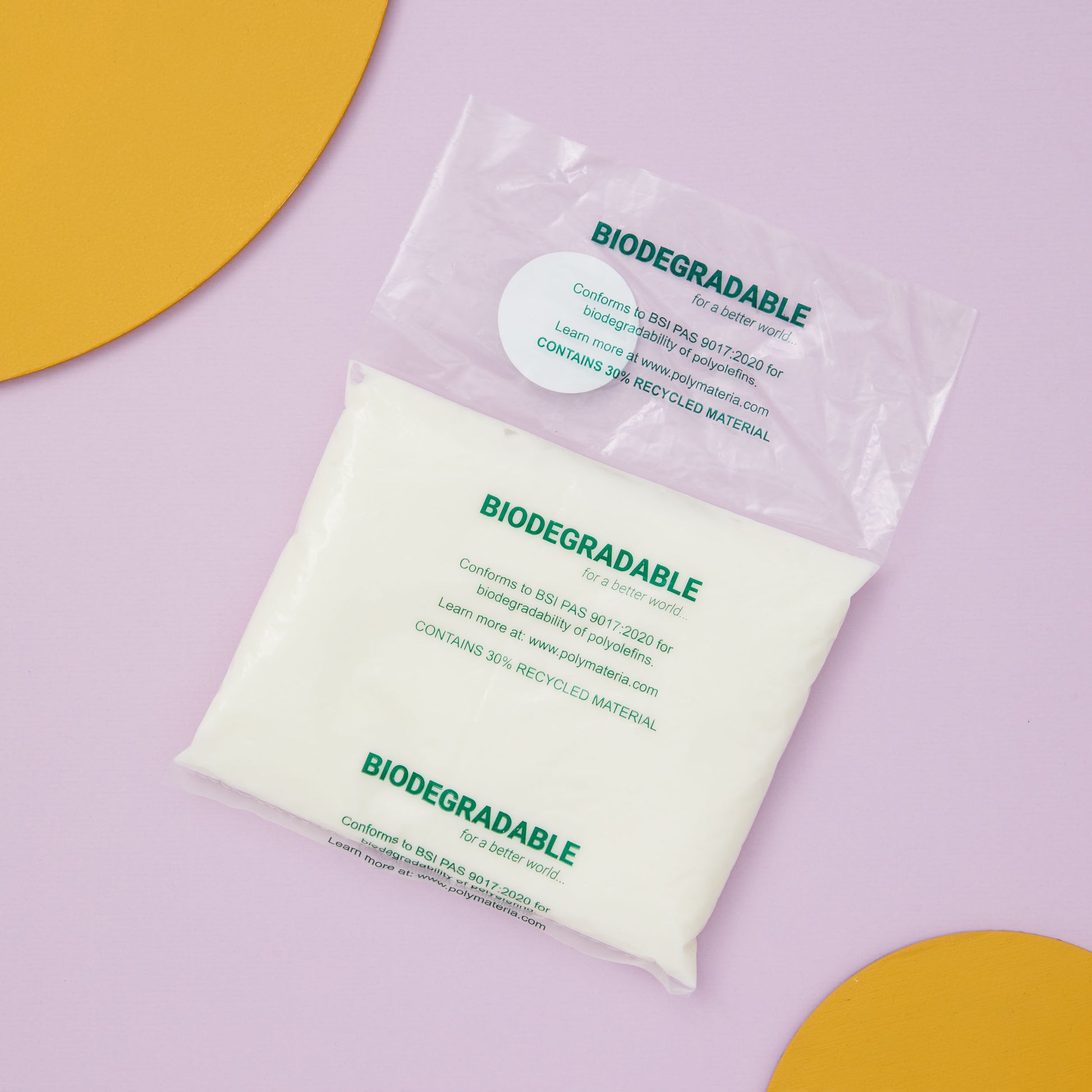 Biodegradable refill pouch packaging on a purple background