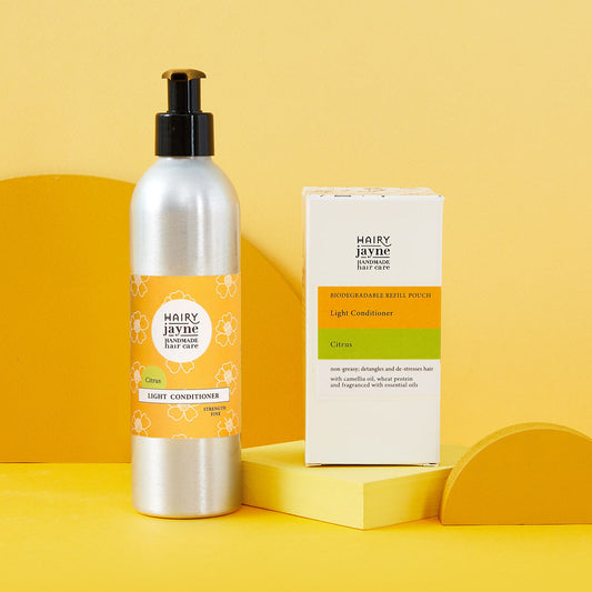 Hairy Jayne light conditioner bottle and refill packaging on a yellow background