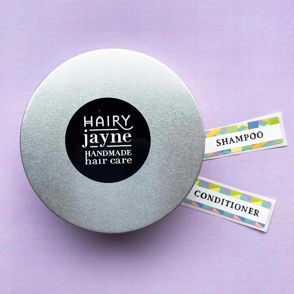 round aluminium travel tin for solid bars with hairy jayne logo and additional stickers for labelling shampoo or conditioner