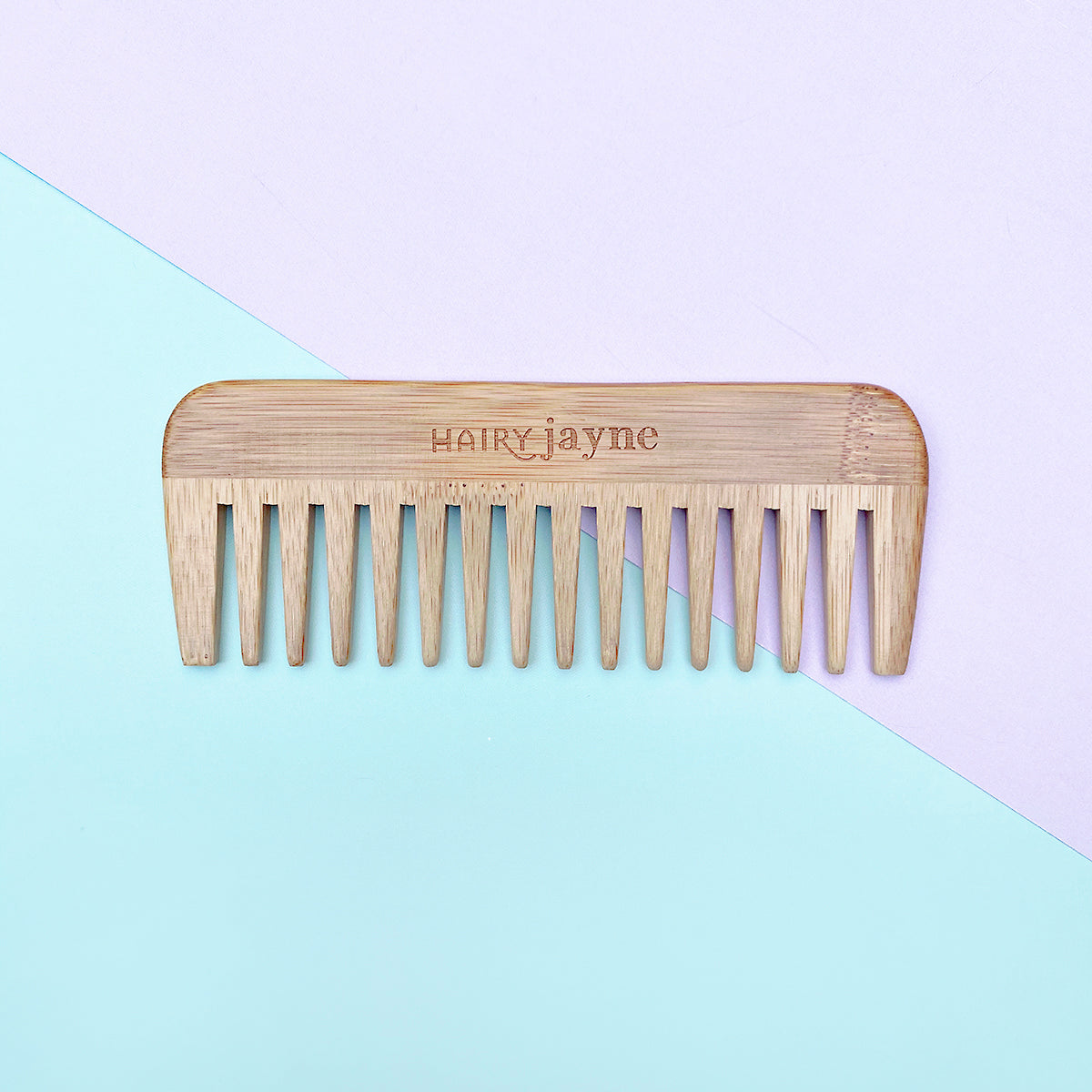 bamboo detangling comb with wide teeth and hairy jayne logo engraved into it