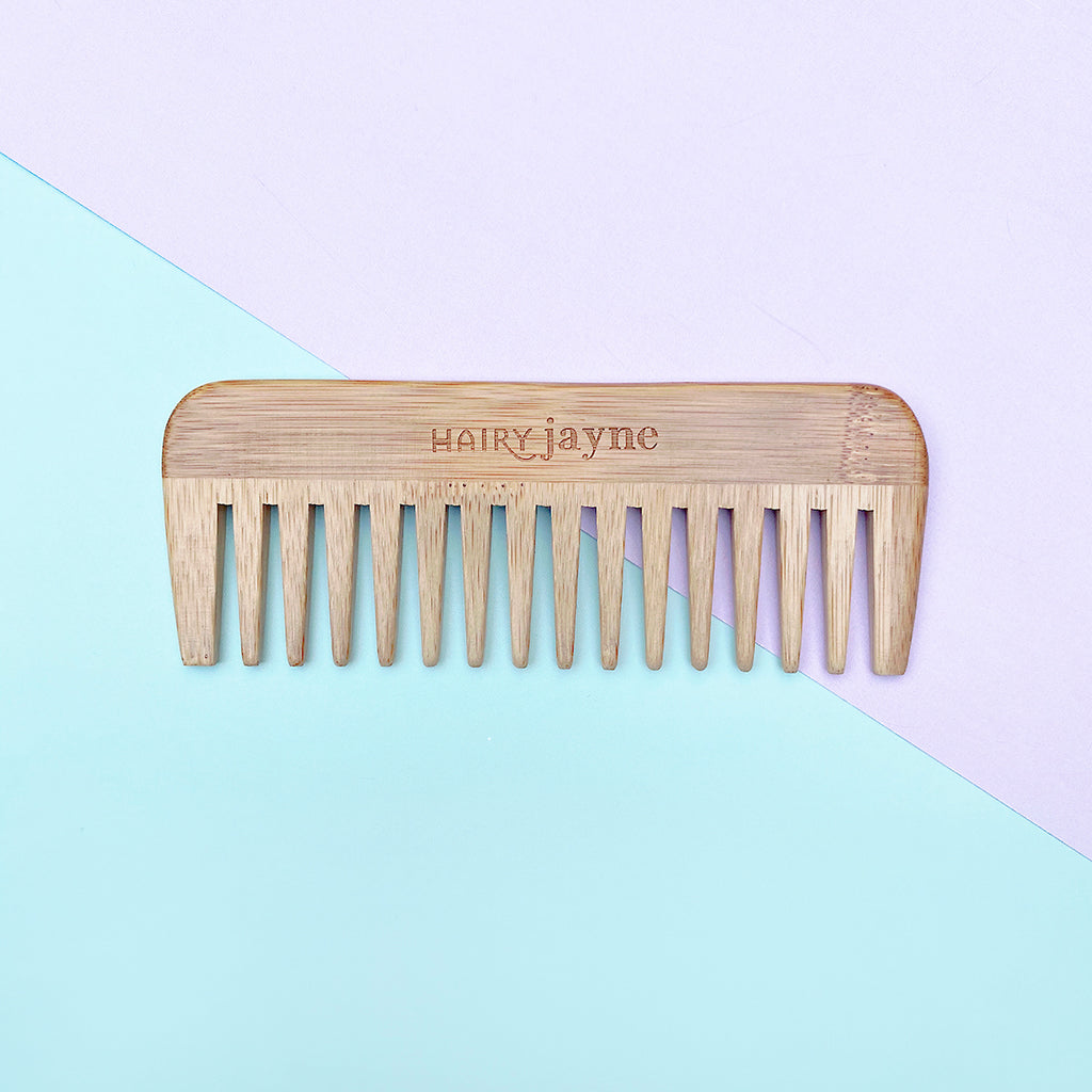 bamboo detangling comb with wide teeth and hairy jayne logo engraved into it